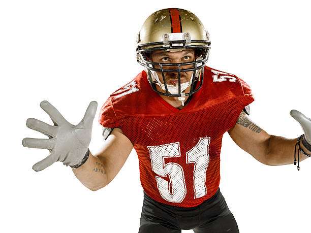 Football player in red jersey with football gloves outstretched.